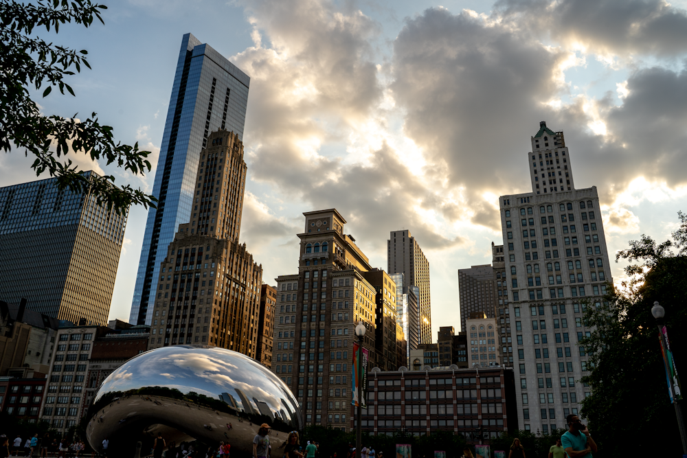 a cloud filled sky over a city with skyscrapers