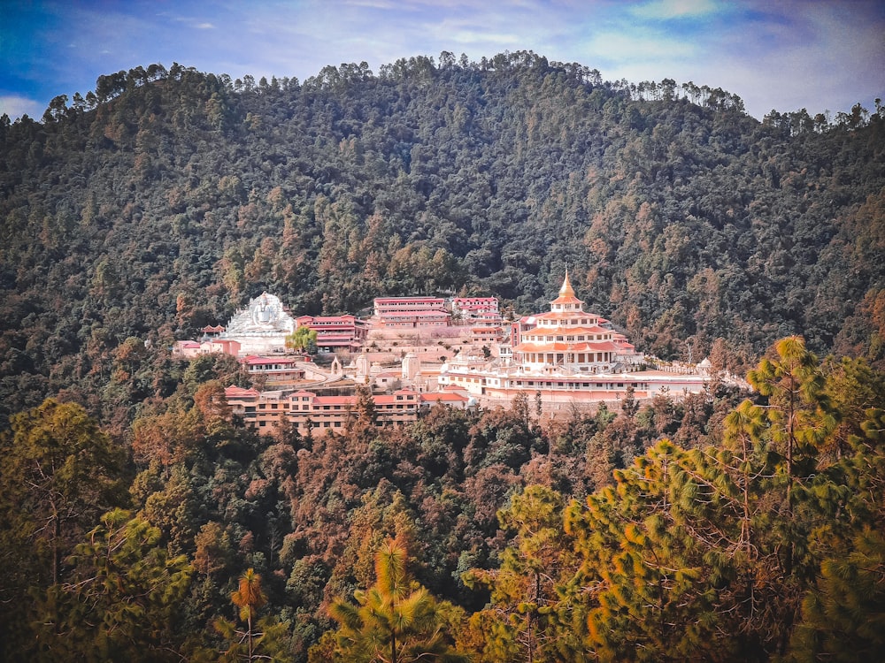 a large building sitting on top of a lush green hillside