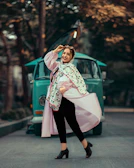 A smiling woman wearing a vibrant Vastraaura co-ord set at a sunny outdoor market