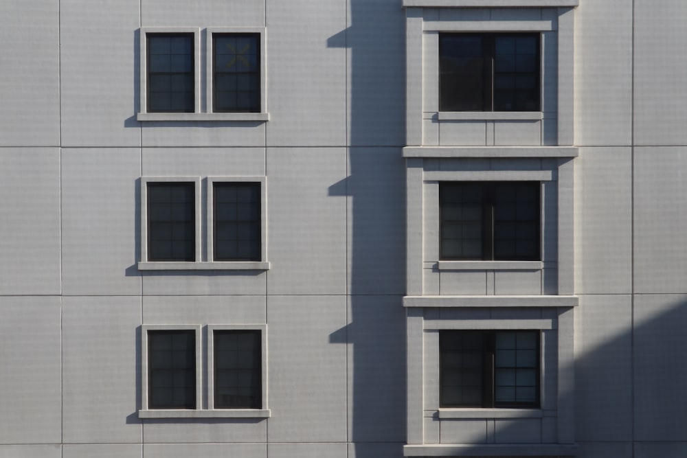 a white building with three windows and a clock