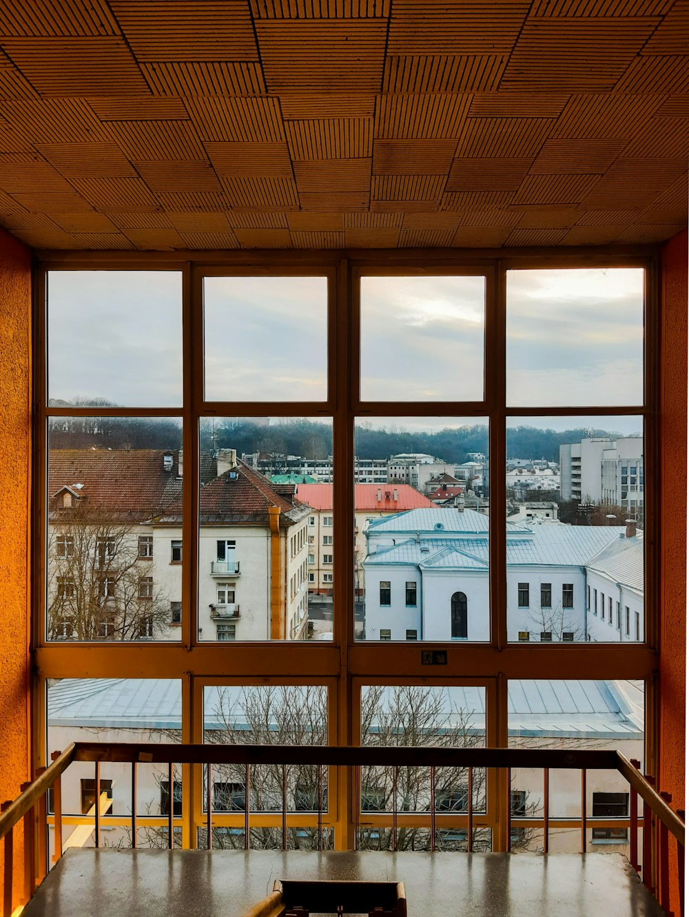 a bench sitting in front of a large window