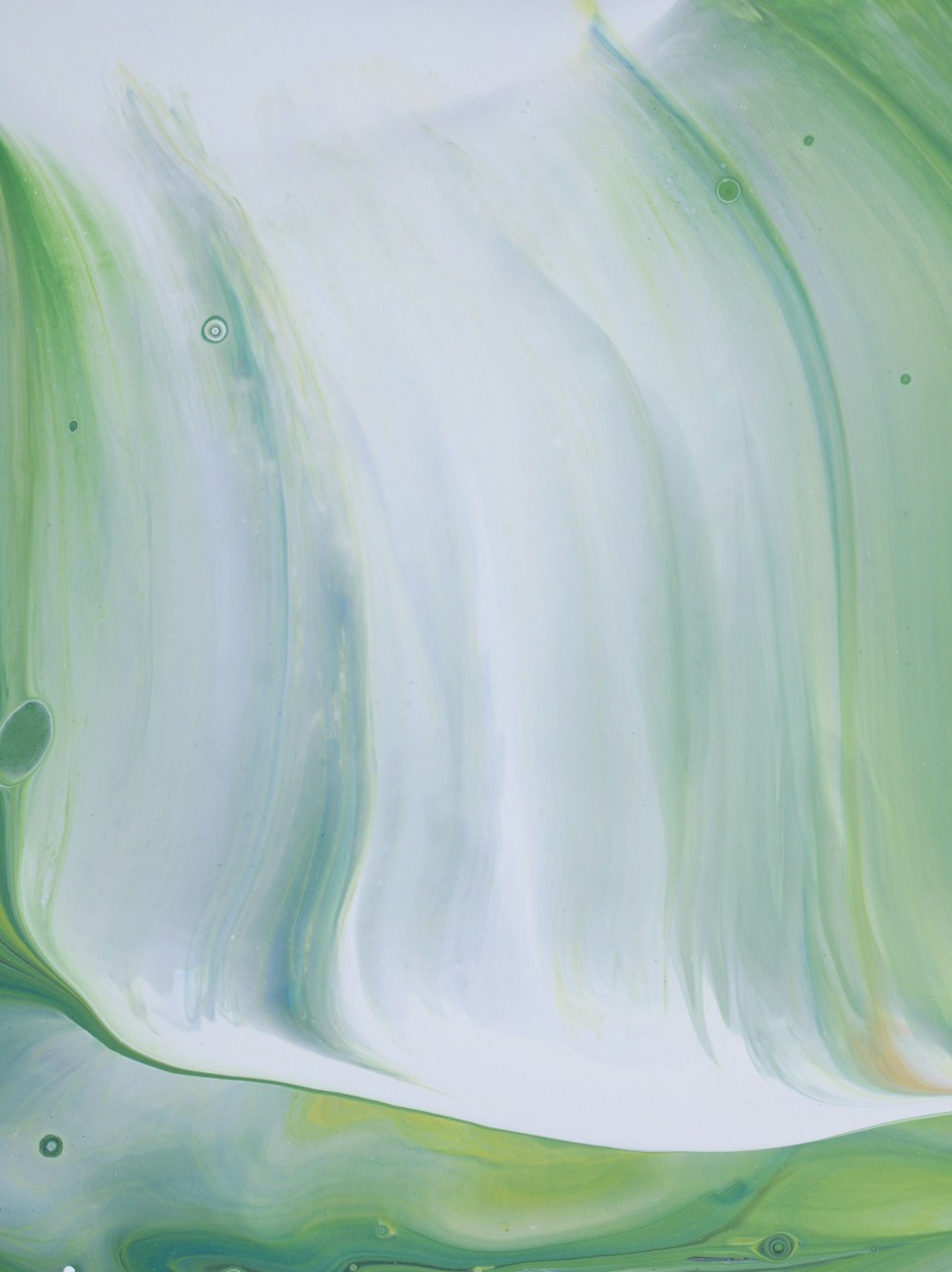 a painting of green and white swirls on a white background