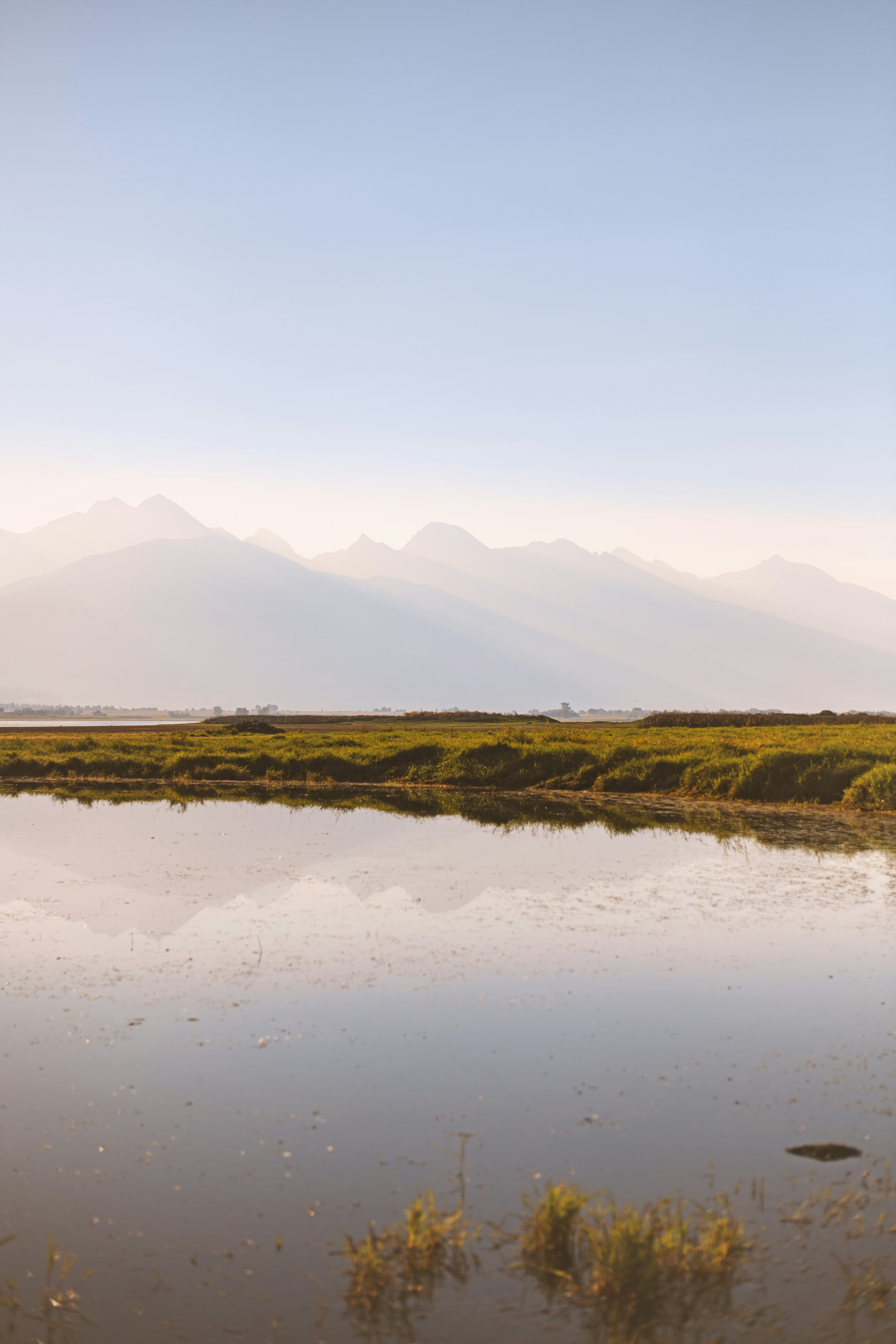a large body of water with mountains in the background