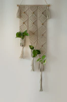 Macramé wall hanging adding warmth and texture above a minimalist desk.