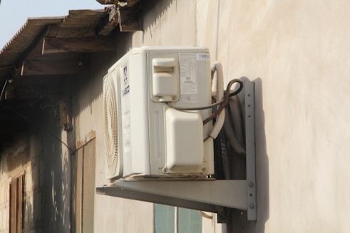 a white phone mounted to the side of a building