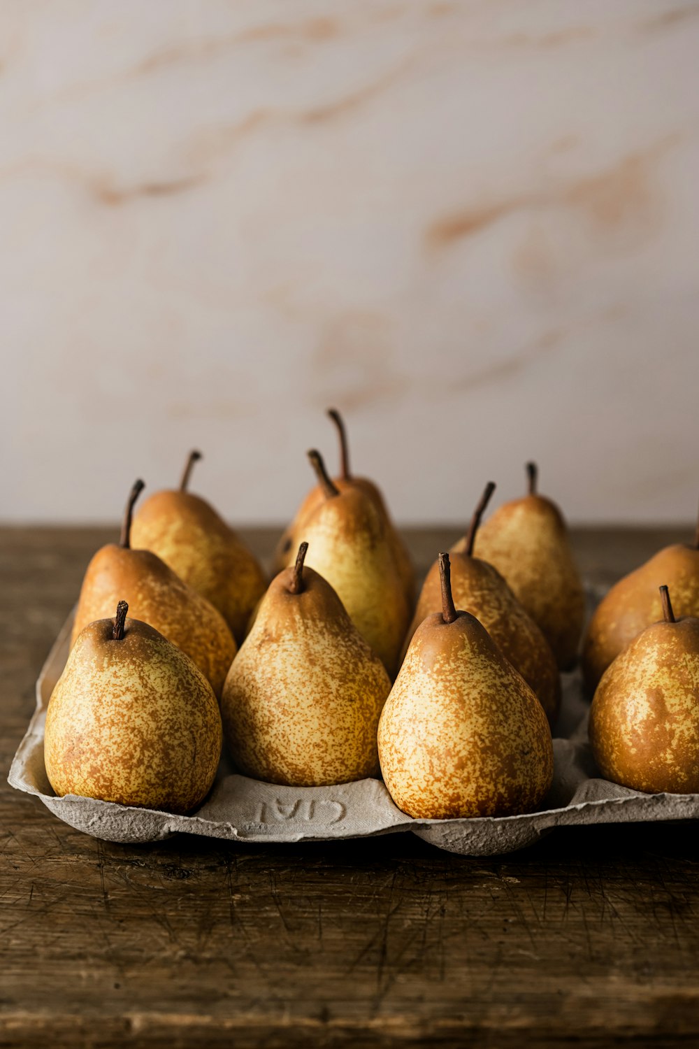 a pear with fruit on top of a wooden table