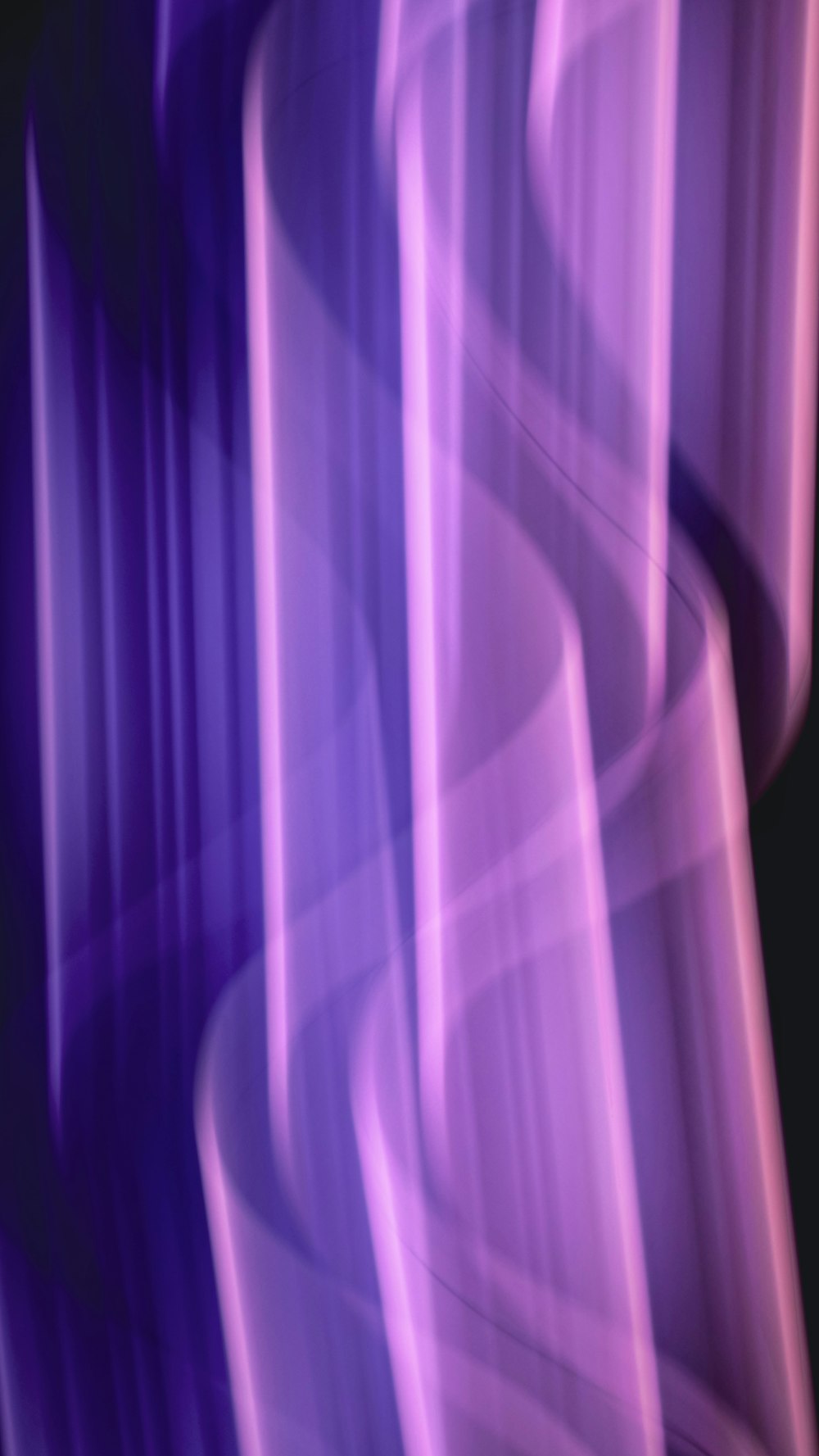 a blurry photo of a purple and black background