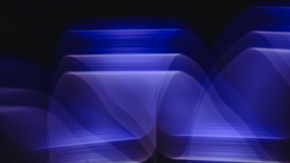 a blurry image of blue vases on a black background