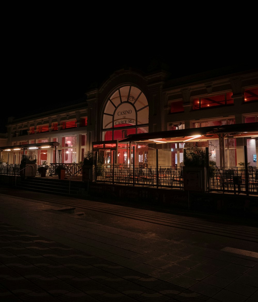 a building lit up at night with red lights