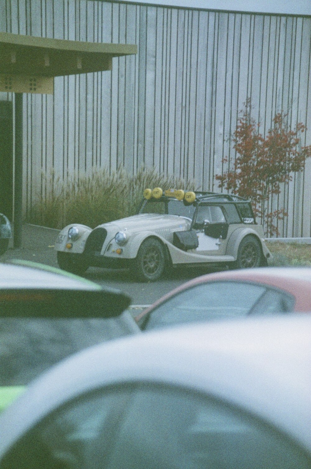 a car parked in a parking lot next to a building