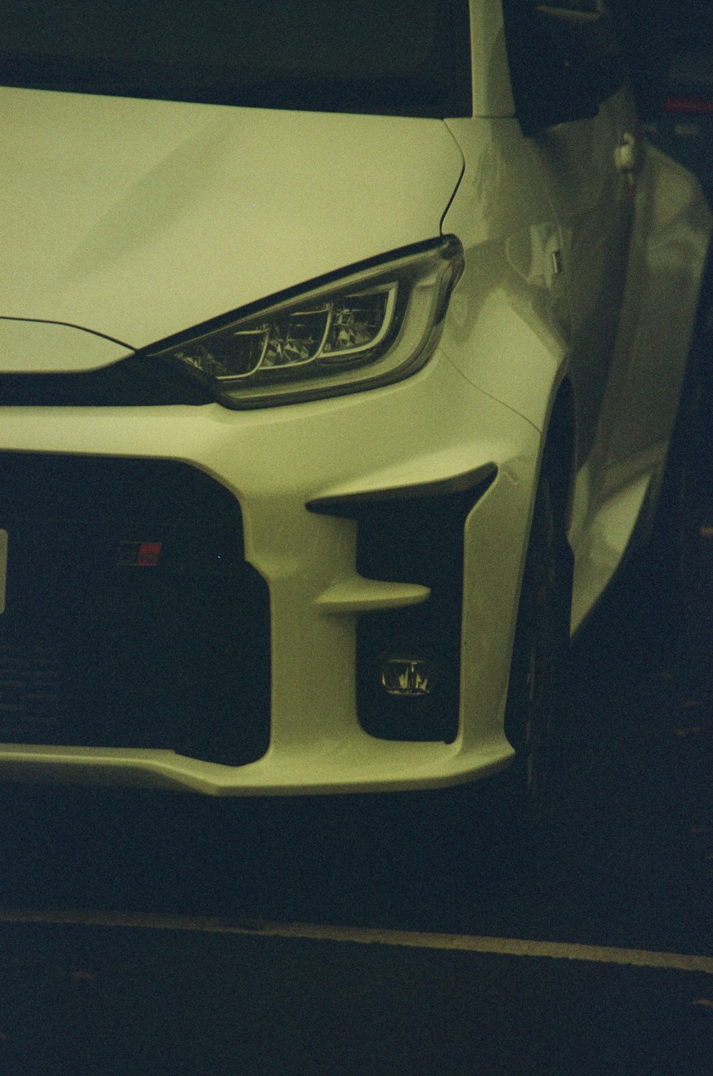 a close up of the front of a white car