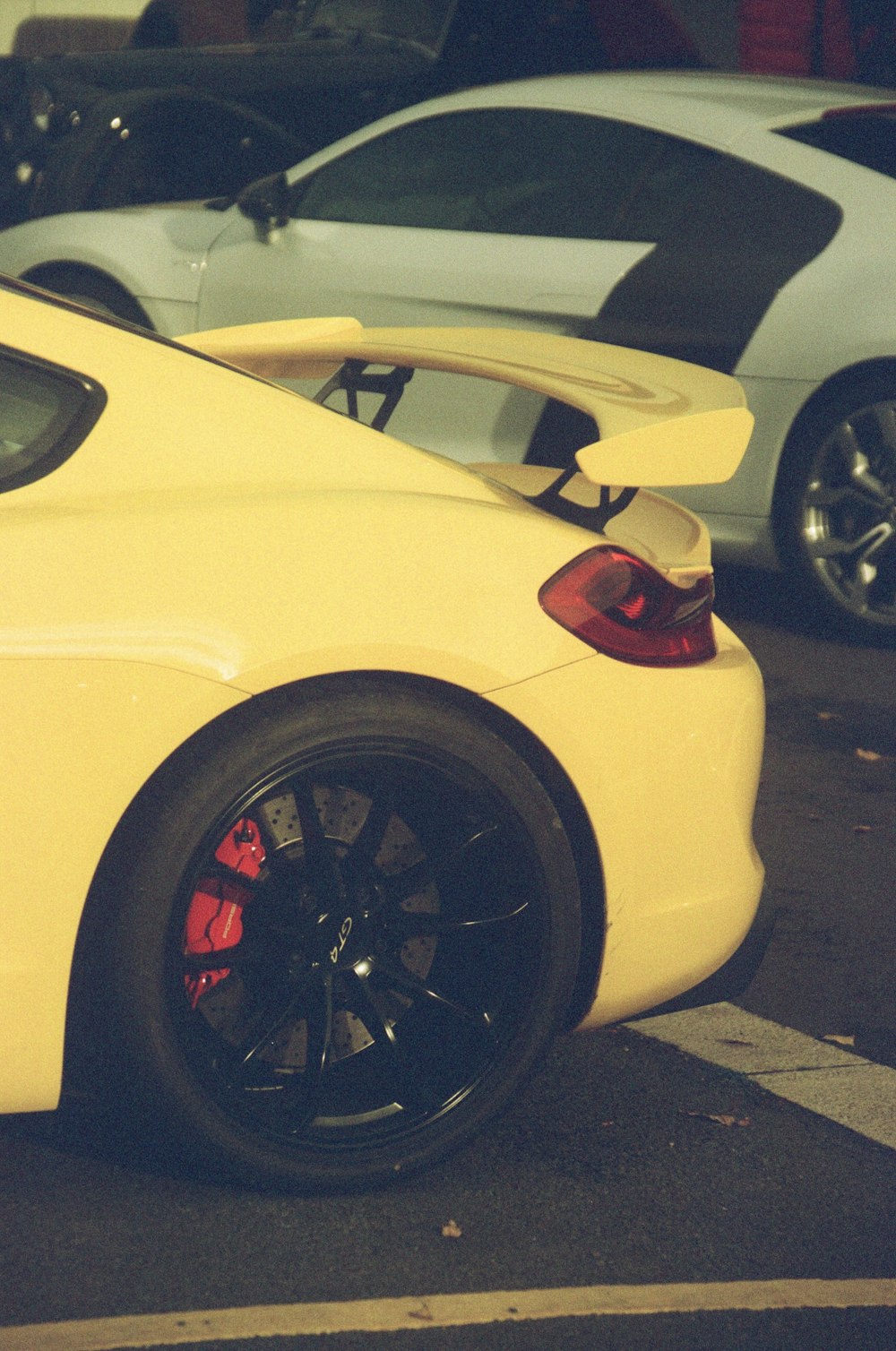 a yellow sports car parked in a parking lot