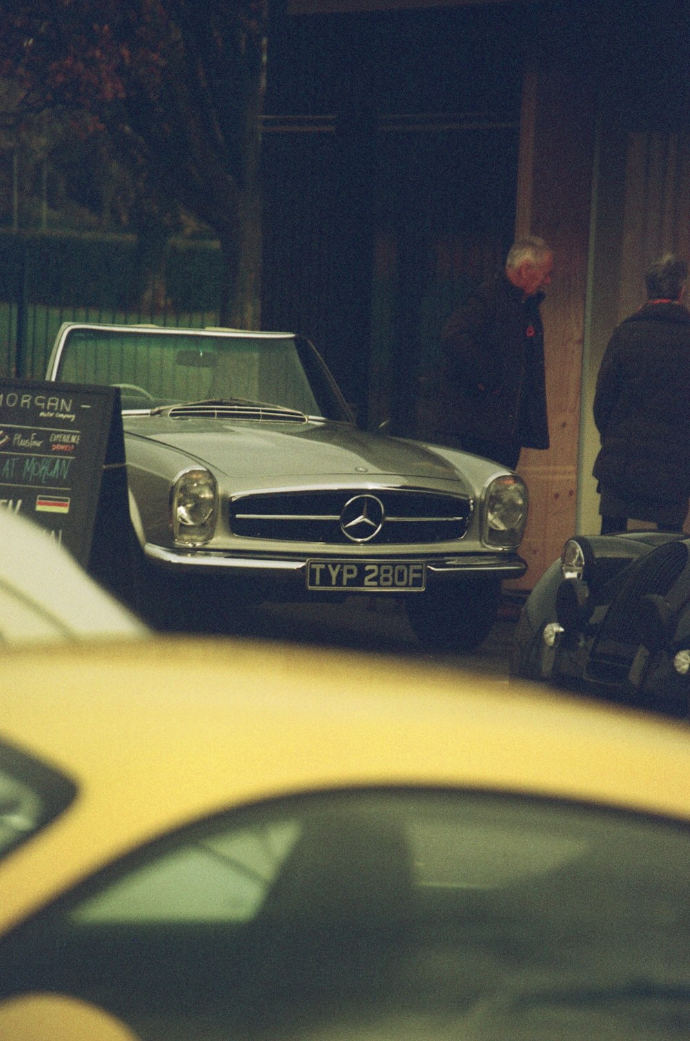 a yellow car is parked in front of a building