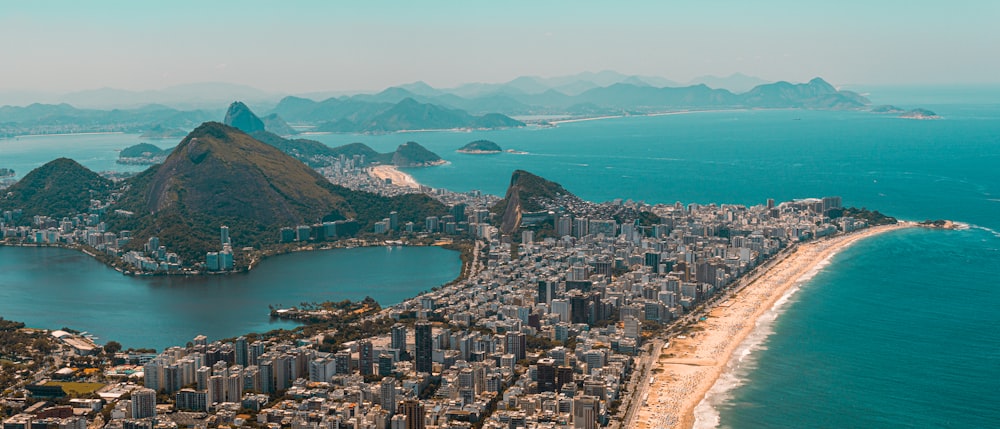 an aerial view of a city with mountains in the background