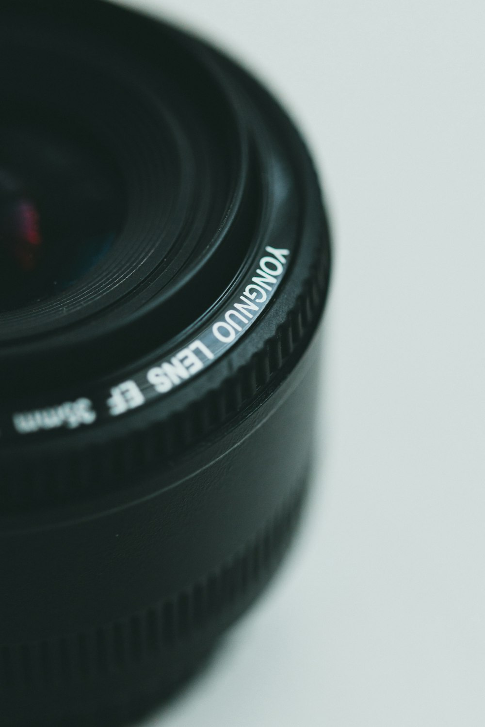 a close up of a camera lens on a white surface