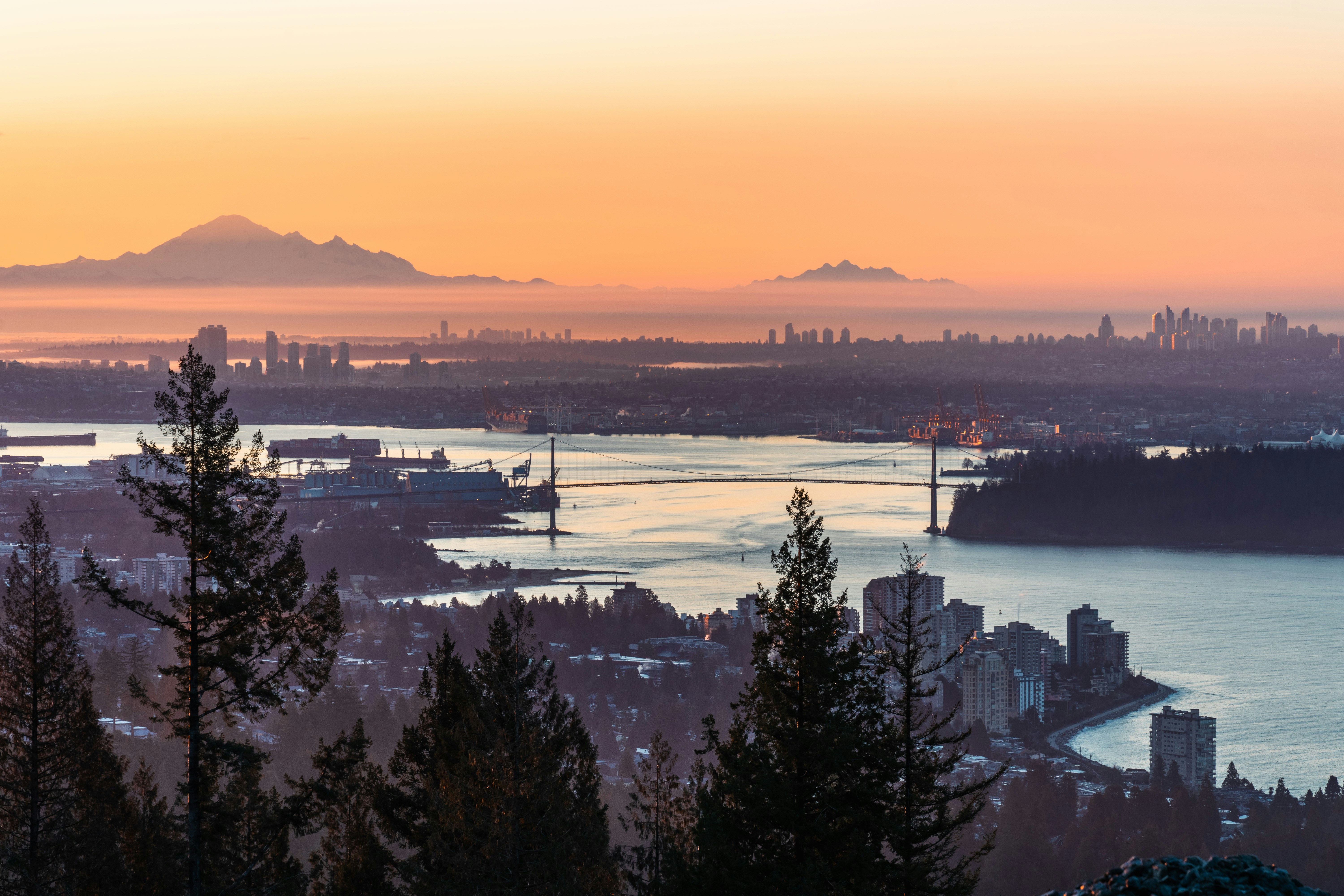 Technician installing a high-efficiency MERV 13 air filter into a residential HVAC system - how lower mainland climate
