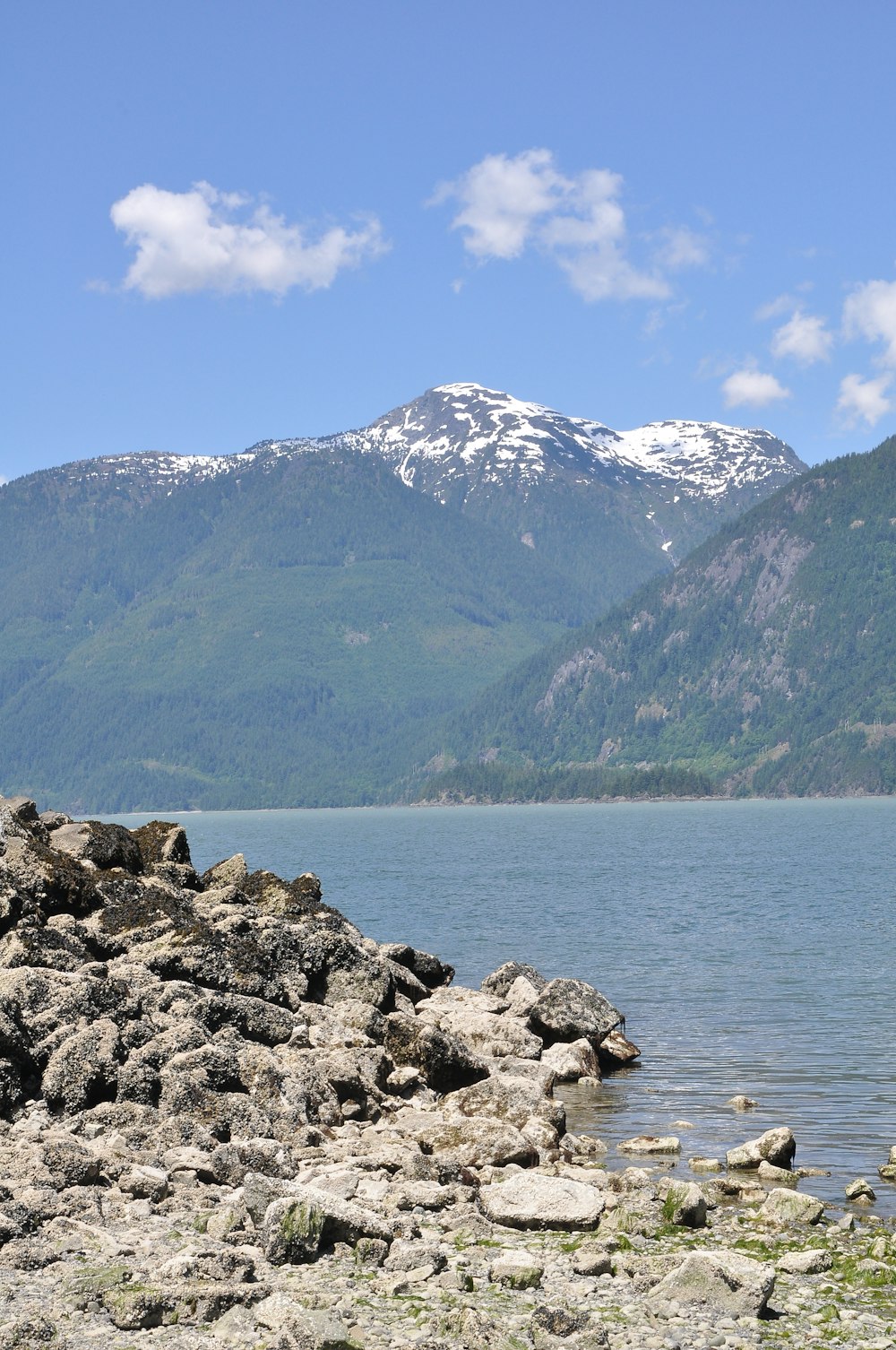 a large body of water with a mountain in the background