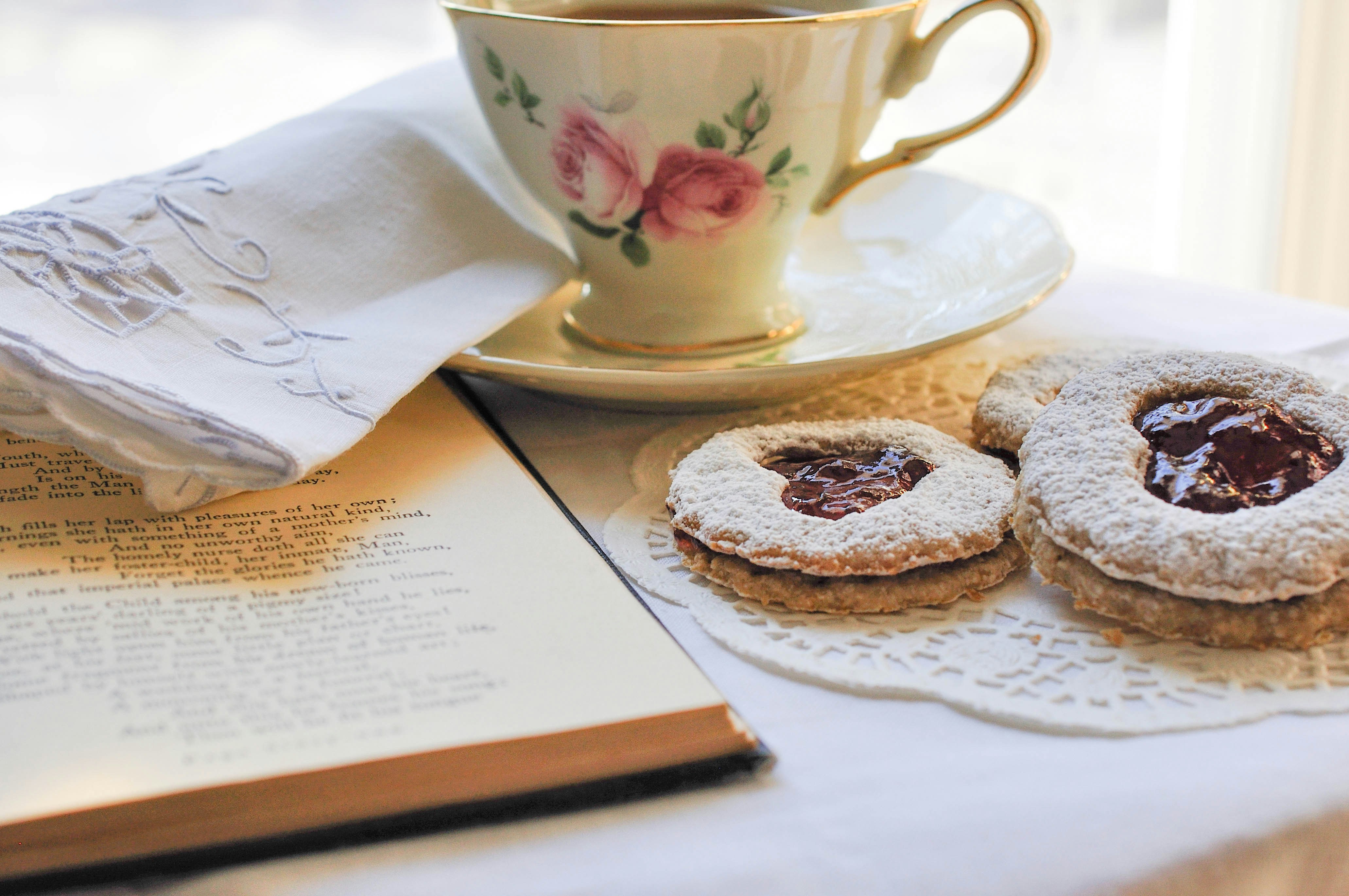 a cup of coffee and some cookies on a table