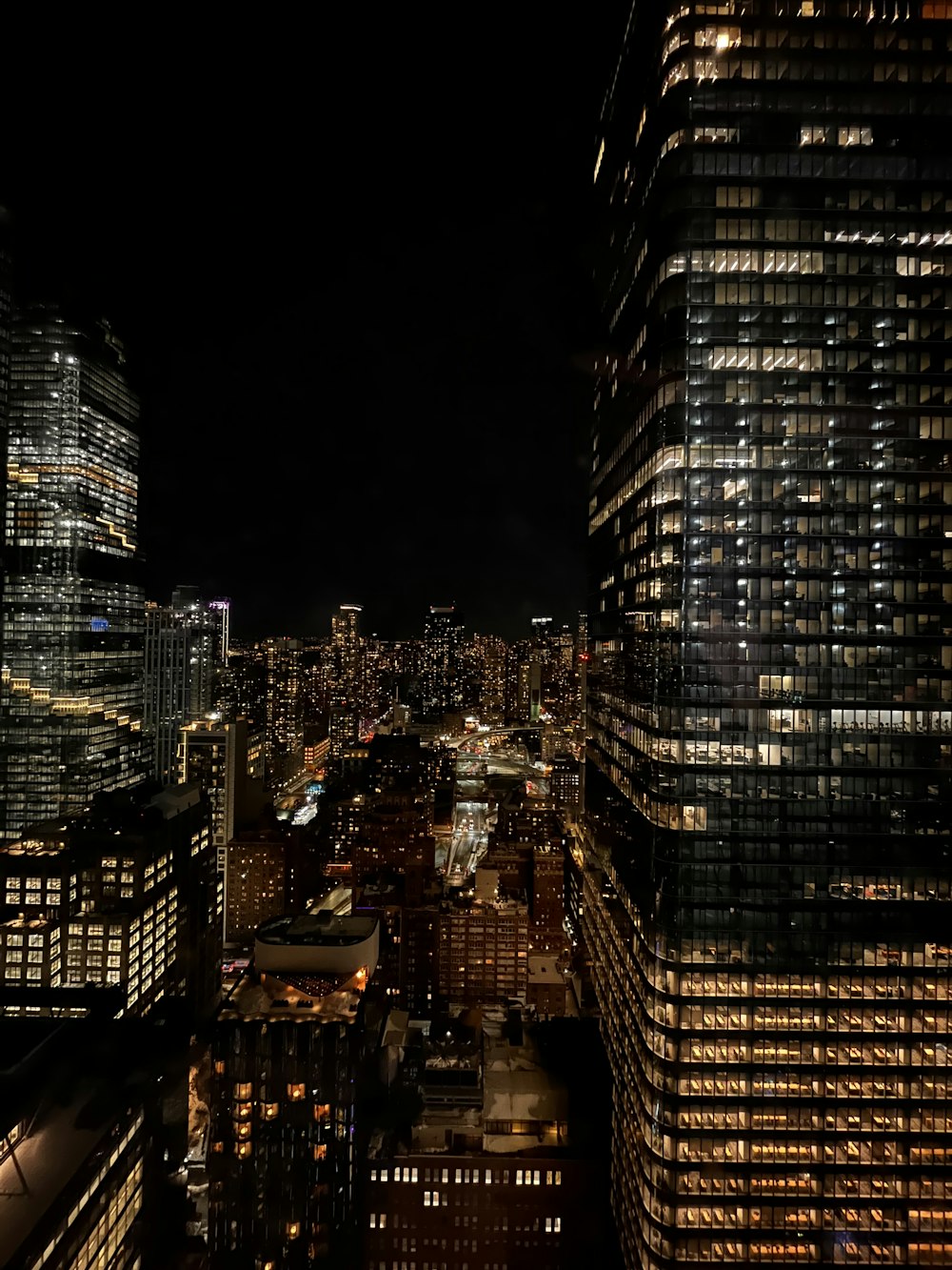 a view of a city at night from the top of a building