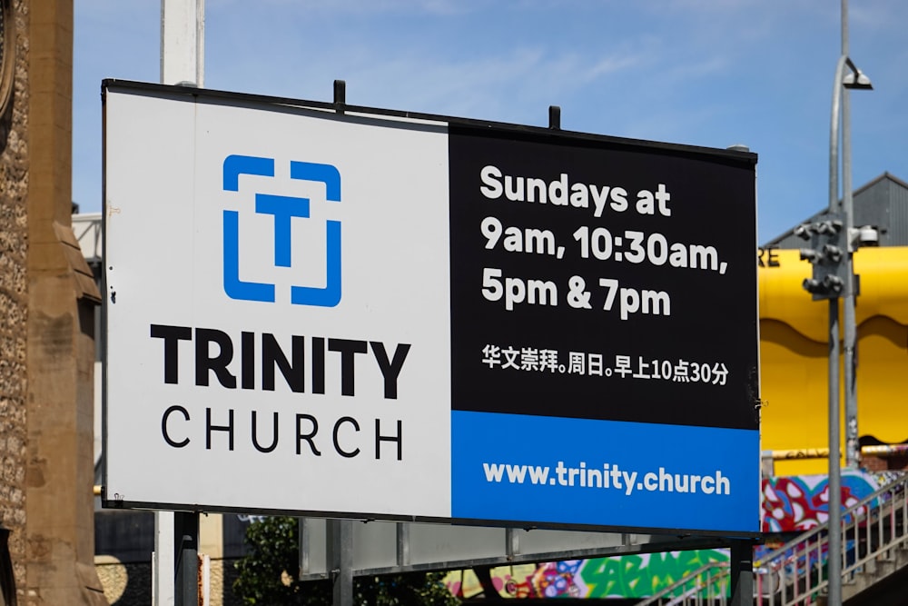 a sign for trinity church on a city street