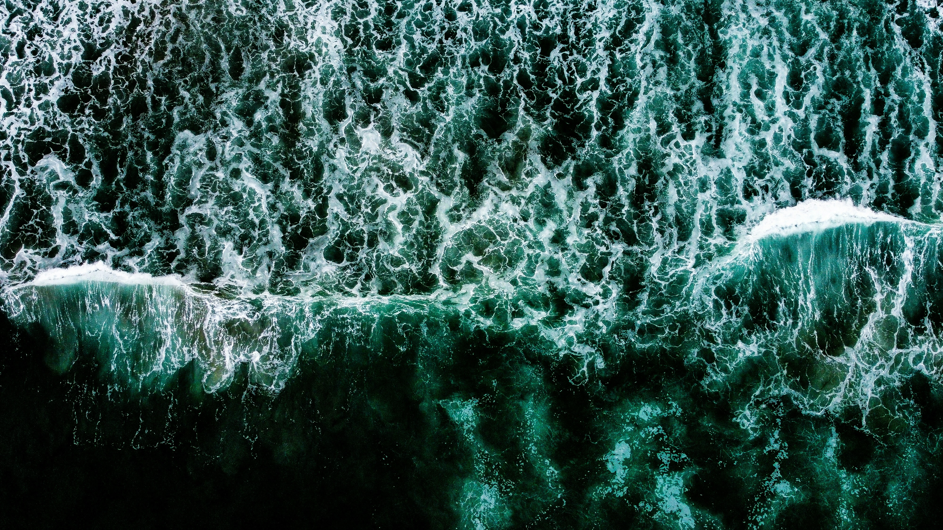 a large body of water surrounded by waves