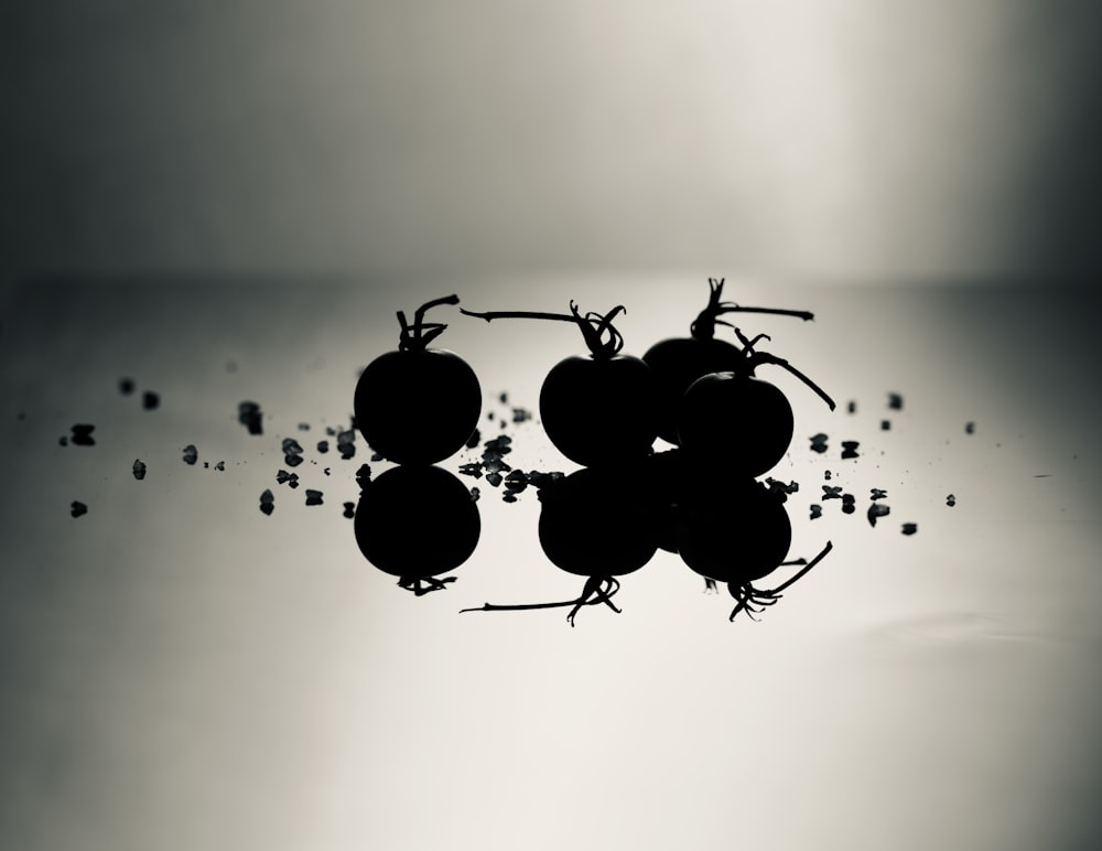 a group of grapes floating on top of a body of water
