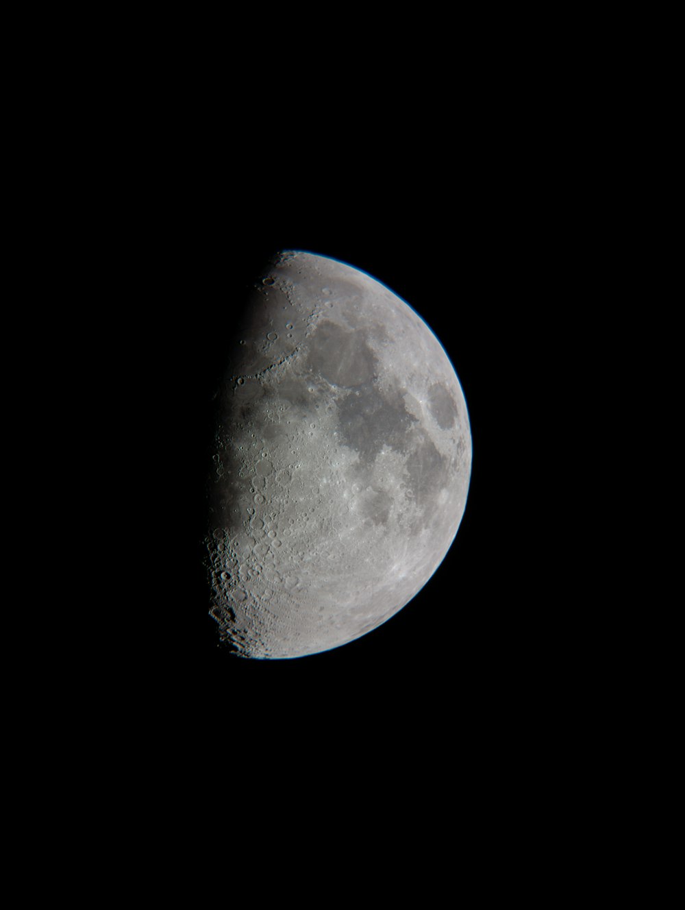 a full moon is seen in the dark sky