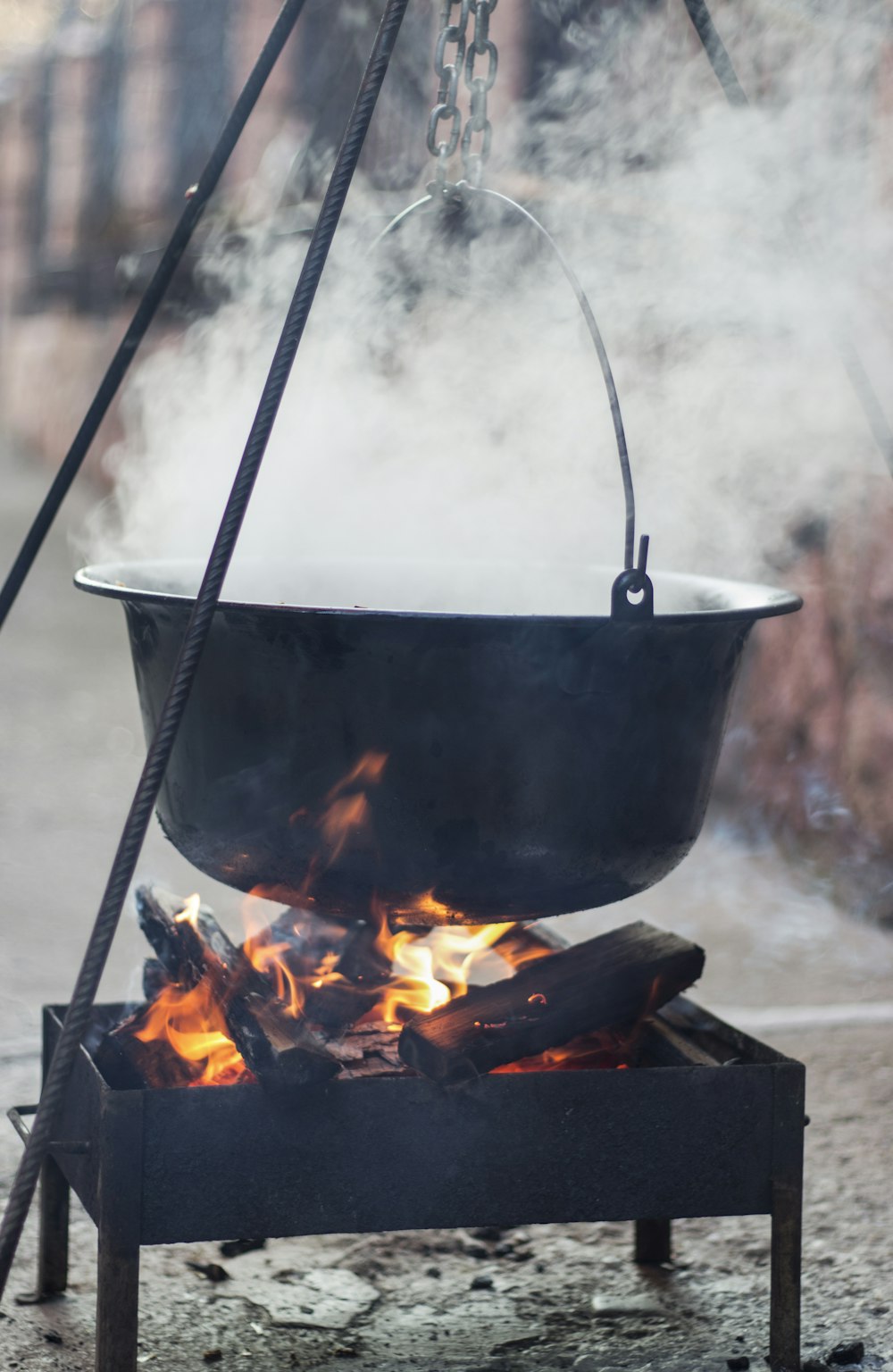 a pot on a stove with a fire in it