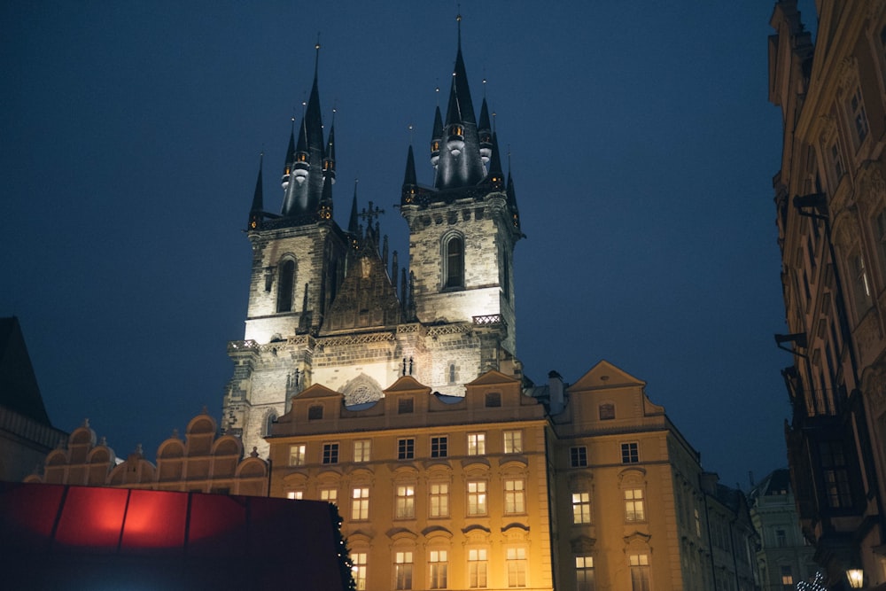 a large building with two towers lit up at night