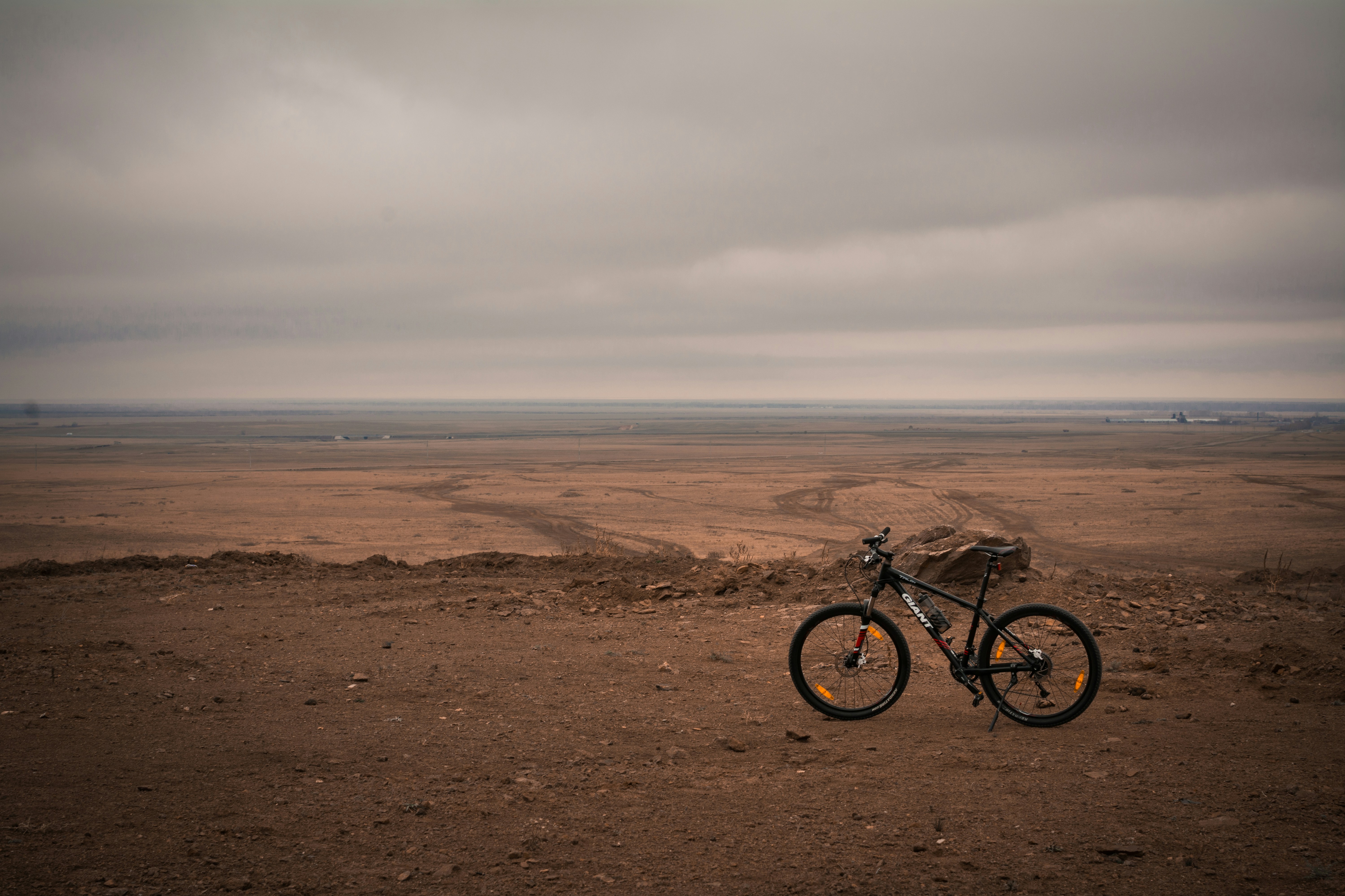 a bike parked in the middle of a desert