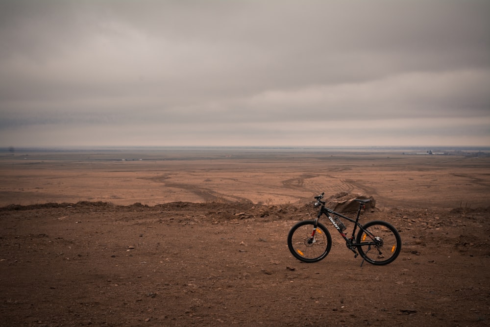 a bike parked in the middle of a desert