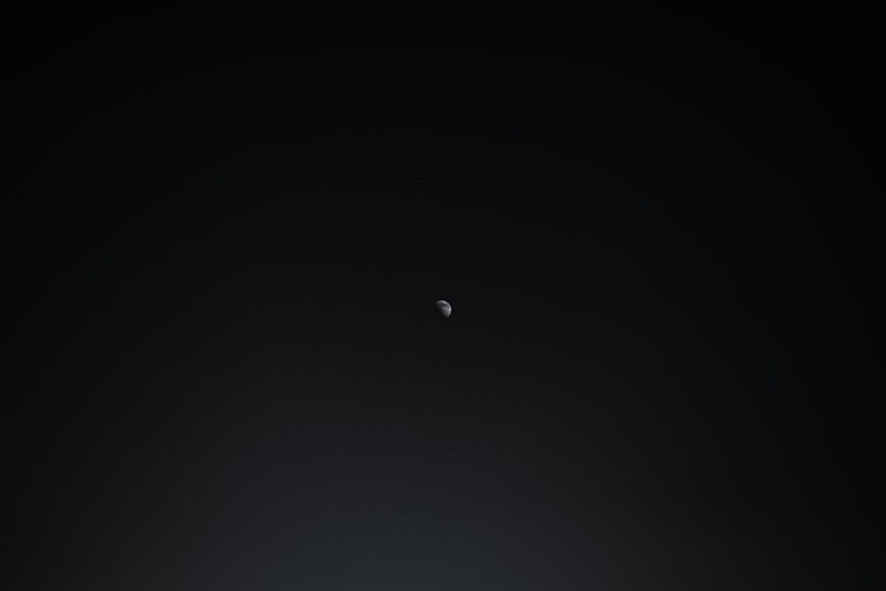 a black and white photo of the moon and earth