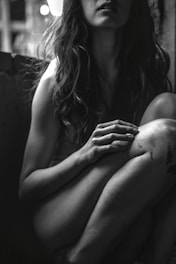 a woman with long hair sitting on a couch