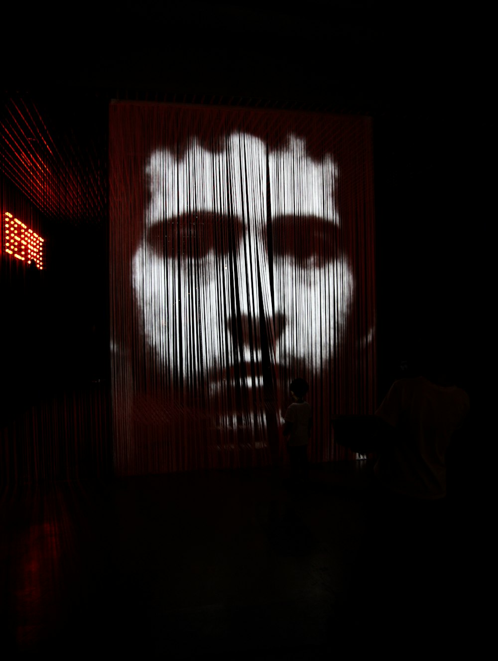 a large screen with a picture of a man's face on it