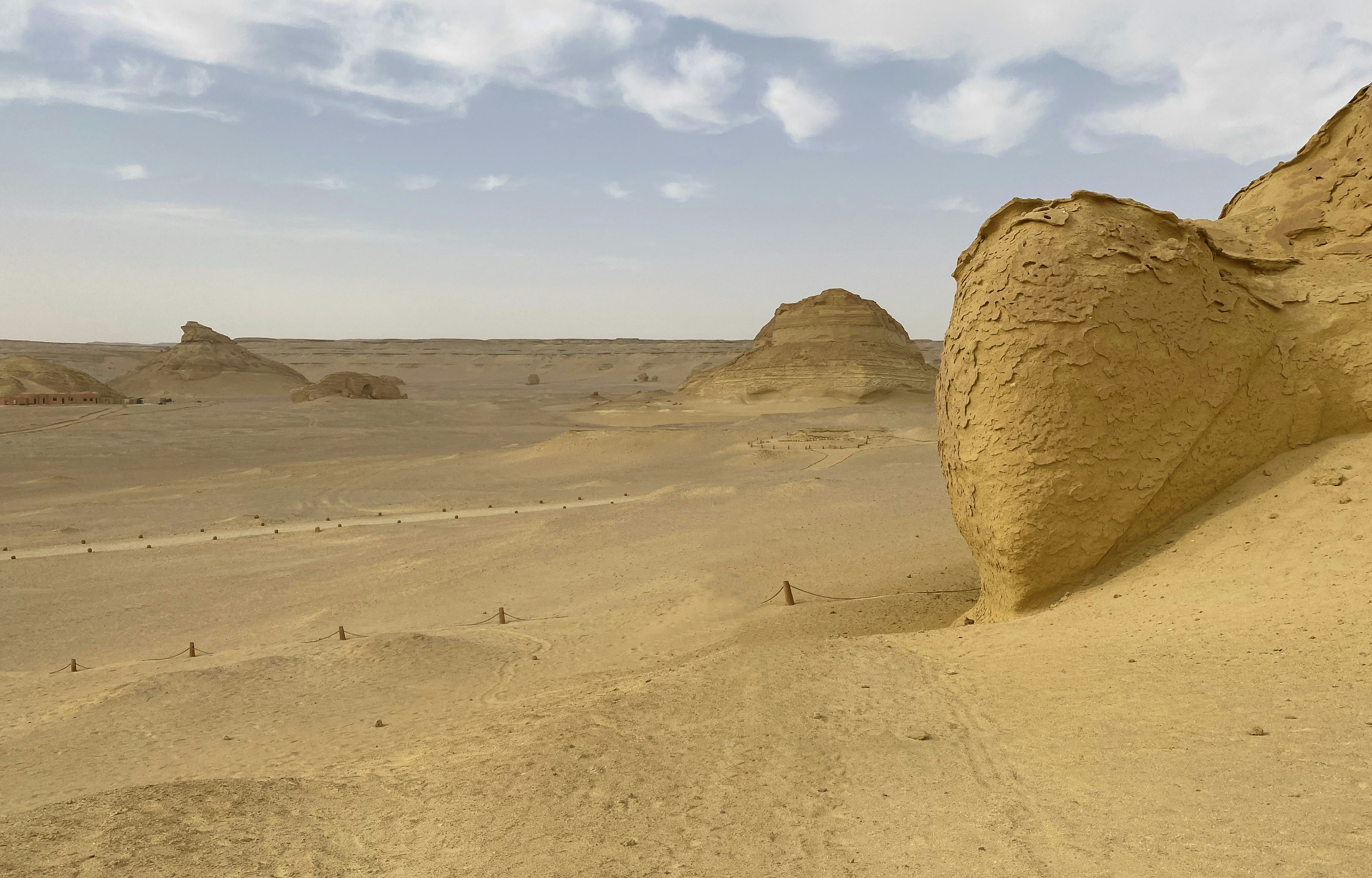 a large rock in the middle of a desert, 