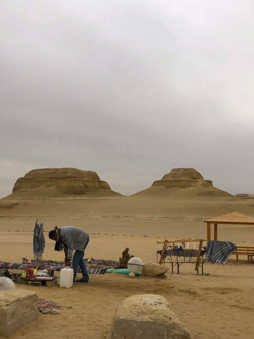 a man standing in the middle of a desert