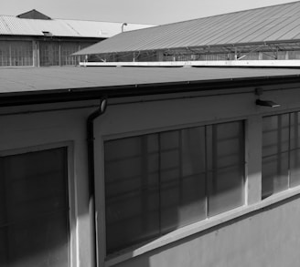 Photograph of a completed metal roof structure on an industrial building.