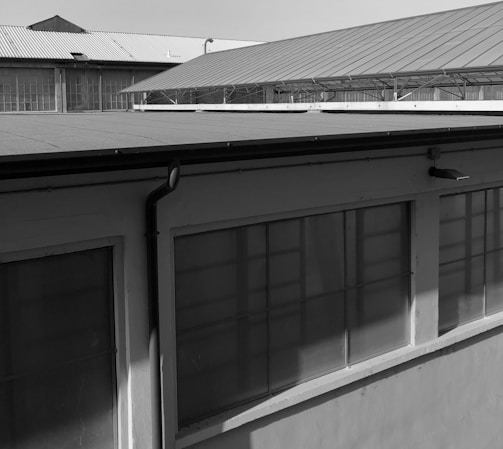 Photograph of a completed metal roof structure on an industrial building.