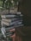A happy customer holding a stack of books from the bookstore.