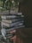 A happy customer holding a stack of books from the bookstore.