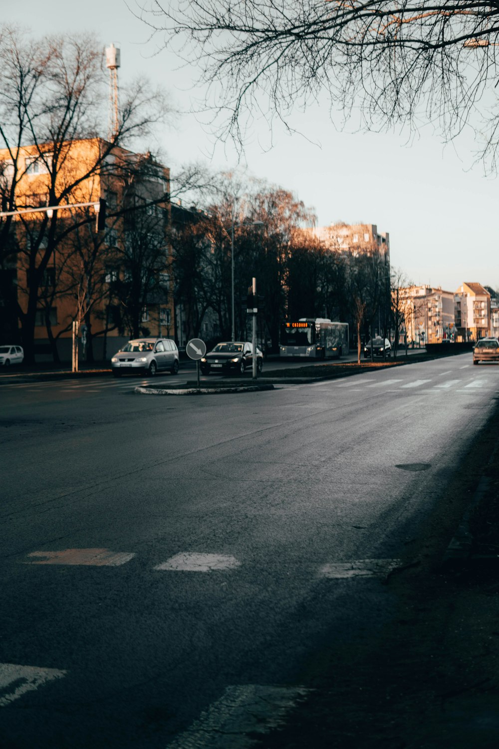 a city street with cars parked on the side of the road