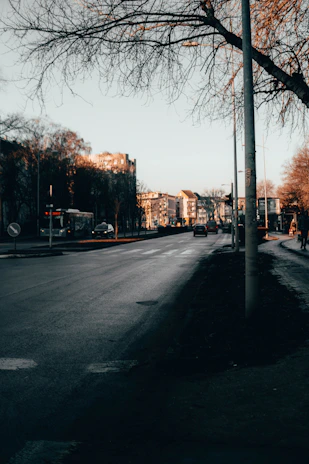 a street with a few cars parked on the side of it