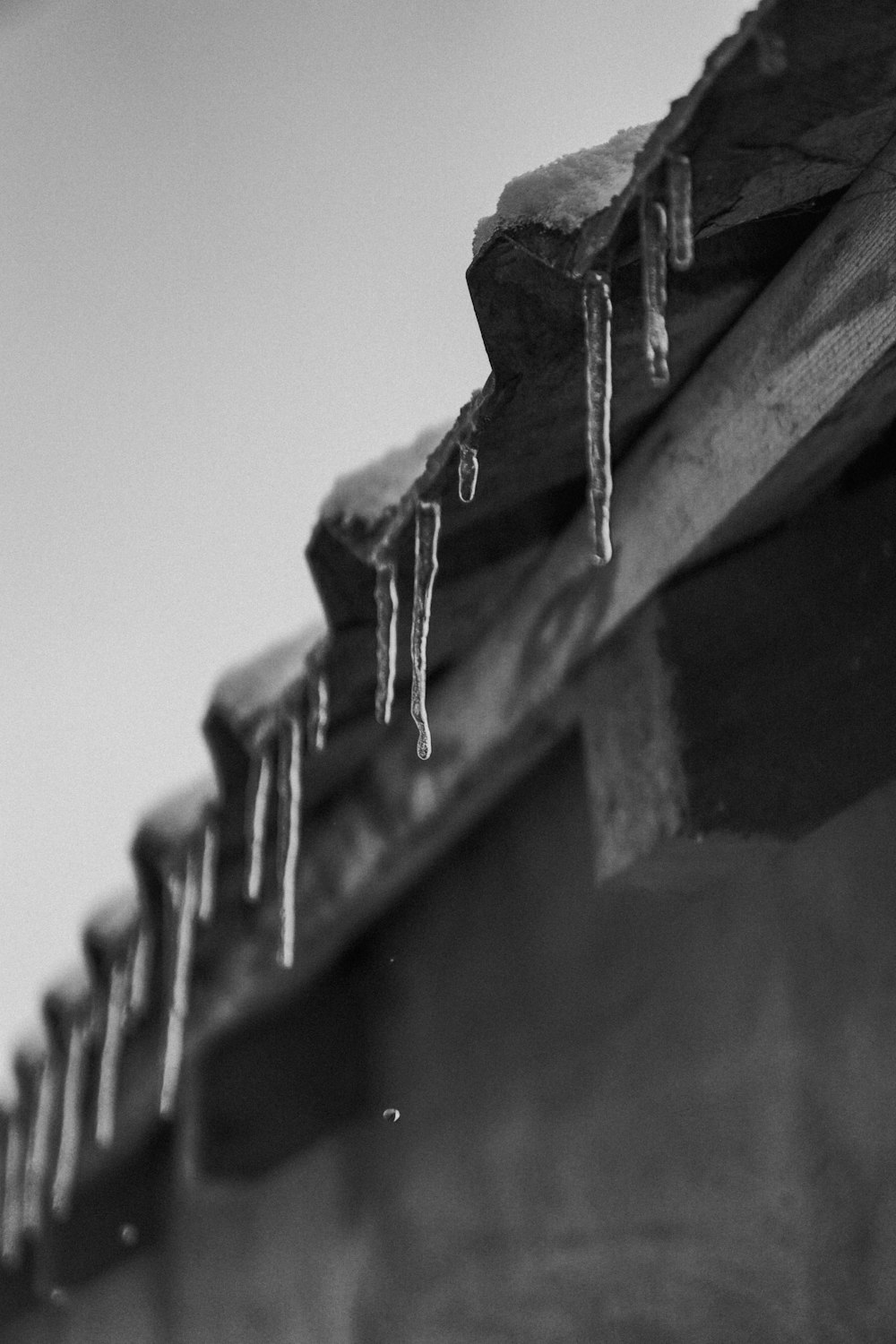 icicles hang from the roof of a building