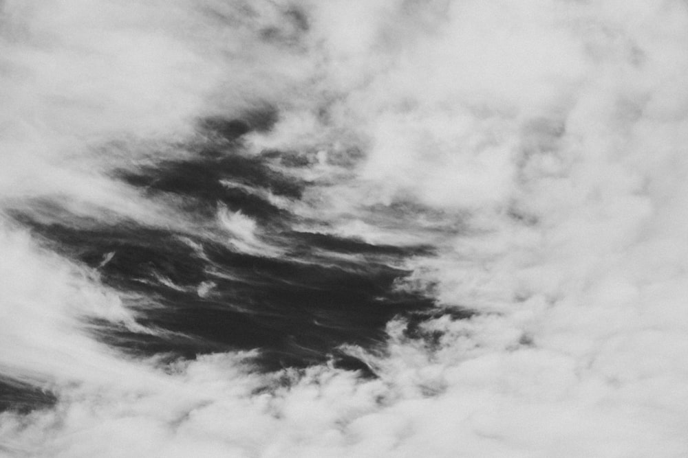 a black and white photo of clouds in the sky