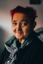 a woman with red hair and a scarf on
