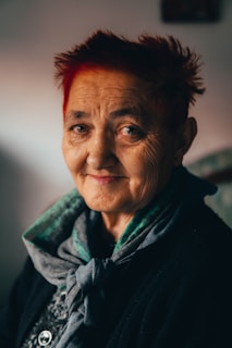 a woman with red hair and a scarf on