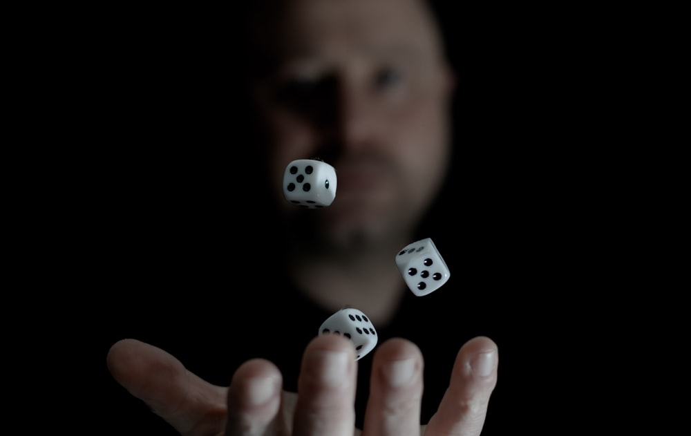 a man is throwing dices into the air