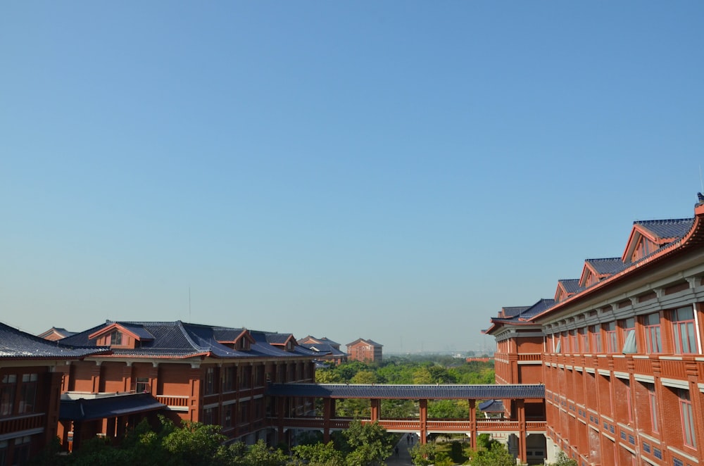 a row of red brick buildings with a blue sky in the background