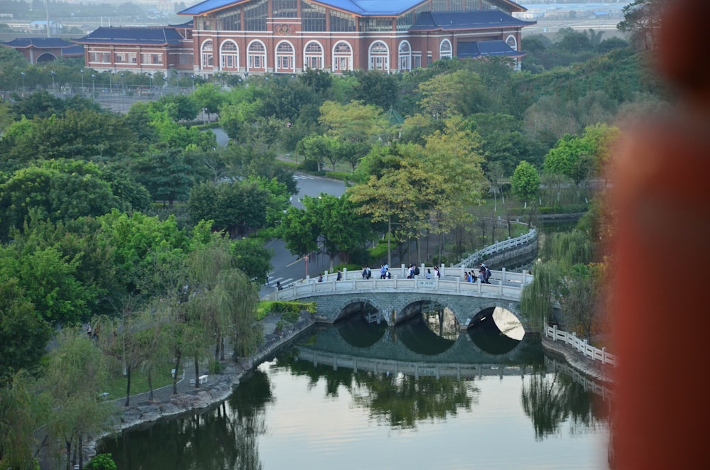 a bridge over a body of water with a building in the background