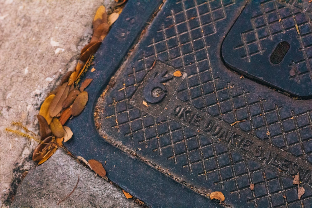 a close up of a manhole cover on a sidewalk
